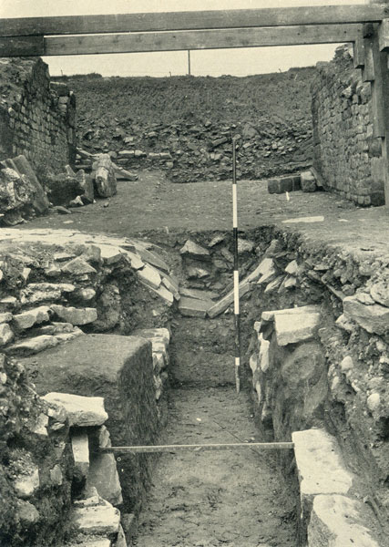 Excavation of Caerleon Amphitheatre 1926 - 1927. Beginning of arena drain, showing collapsed paving, entrance F in background.