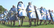 Members of the Roman Military research Society form a wedge to charge the enemy.